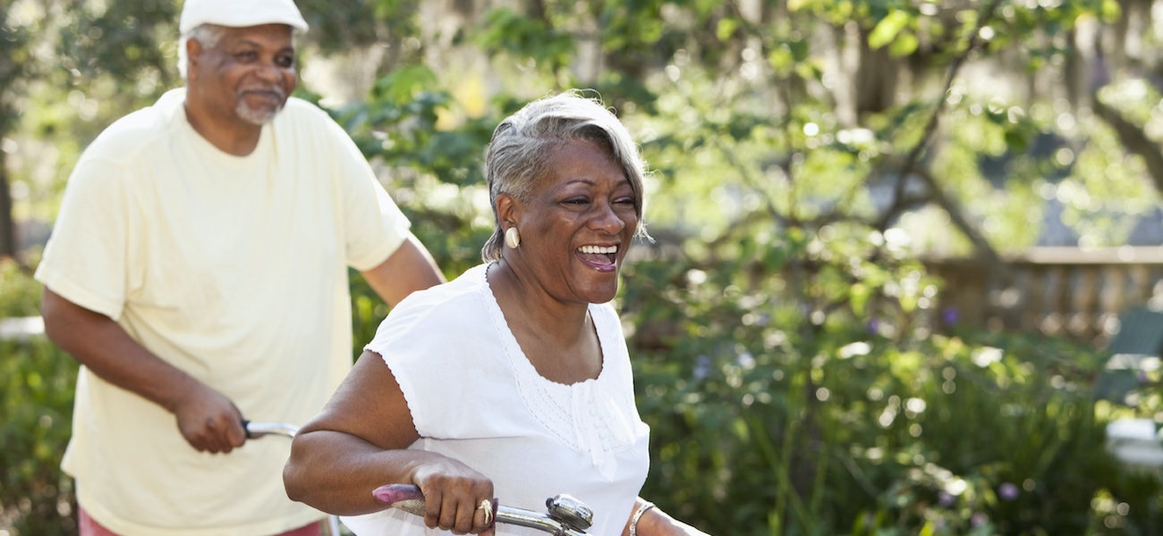 Senior couple riding bikes together in a park